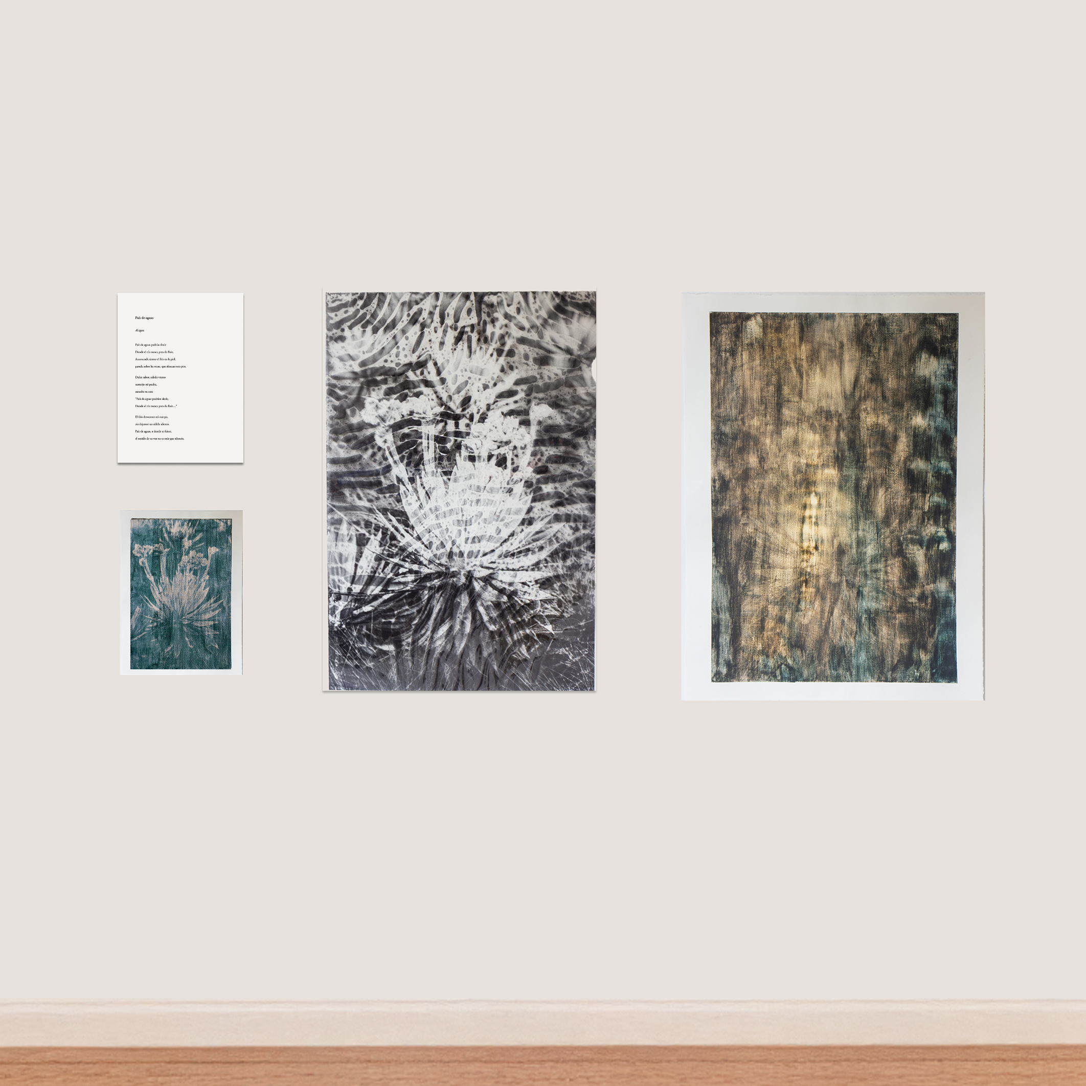 Gallery wall with three framed textured prints in black and white and gold tones.
